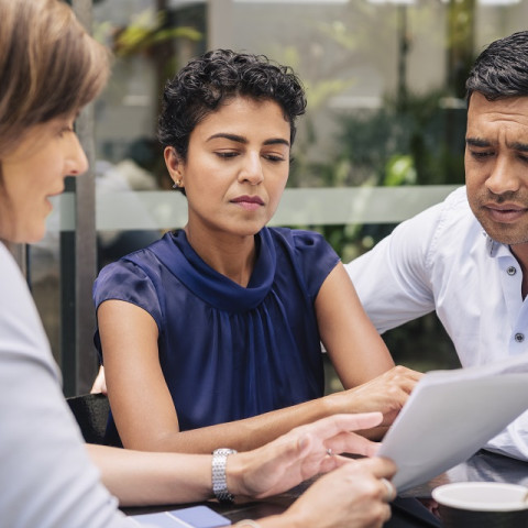 Liability insurance broker talking to business owners.			