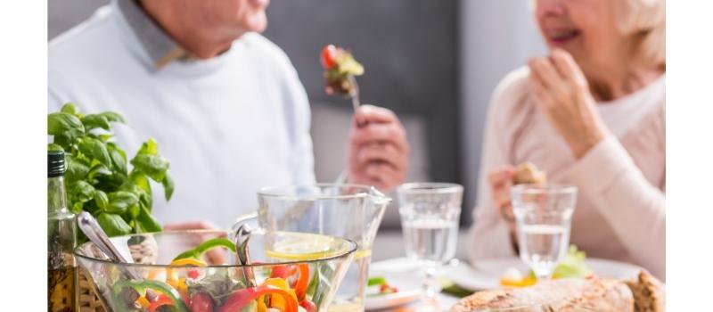 A couple of retirement village residents enjoy a healthy meal together