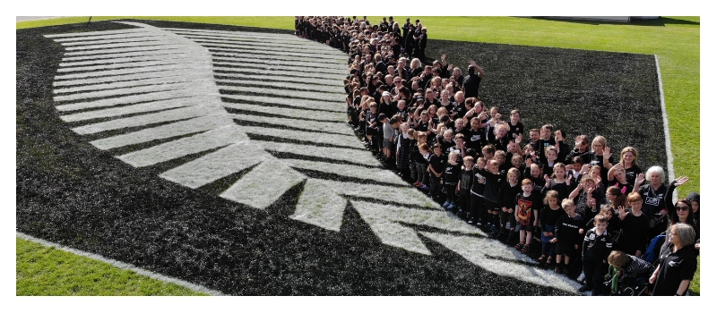 St. Anne's school pupils with a giant silver fern painted on their field
