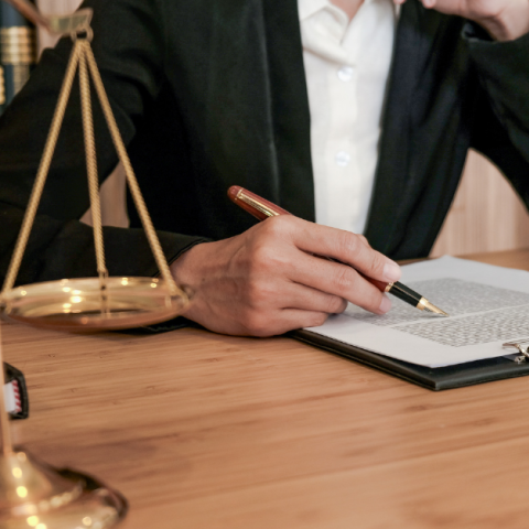 justice scales and person with pen