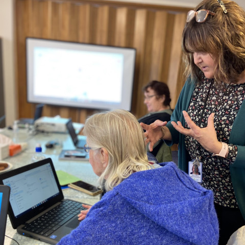 Digital coach talking with a student using a laptop