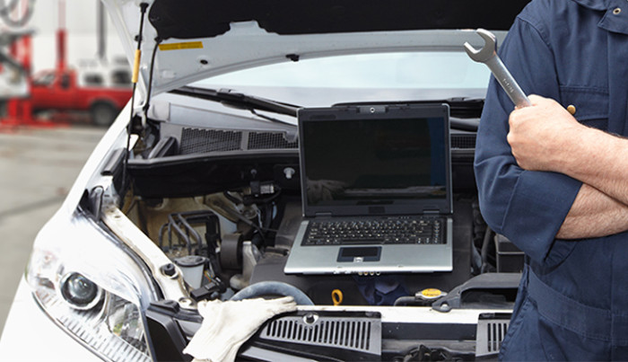 Mechanic works on a car engine 