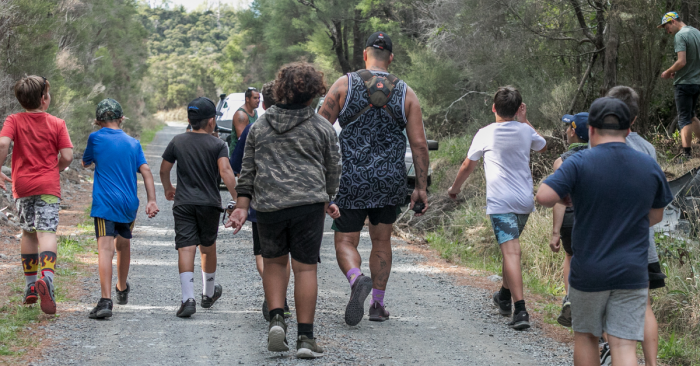 Group of boys walking in the bush 